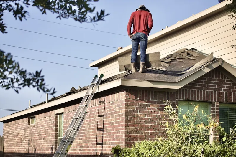 Professional roofer working on a residential roof in Middlebush